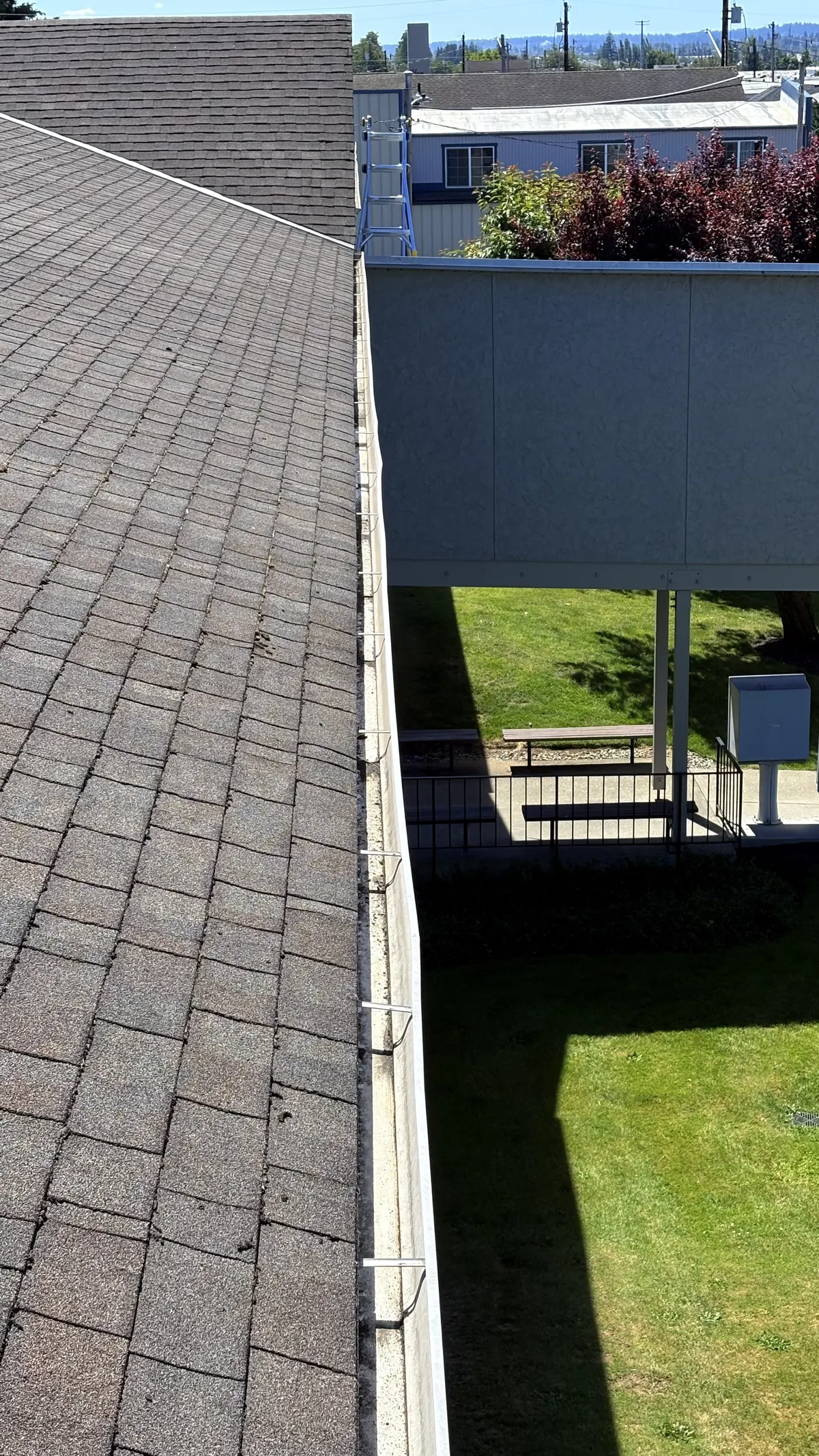 Cleared gutter running along a roof edge above a courtyard