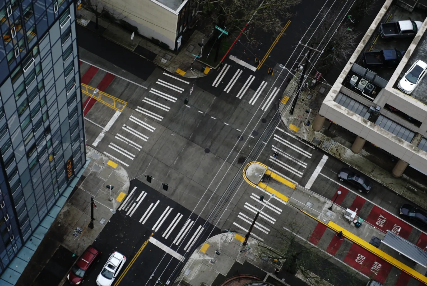 Looking straight down at a crosswalk intersection far below the building